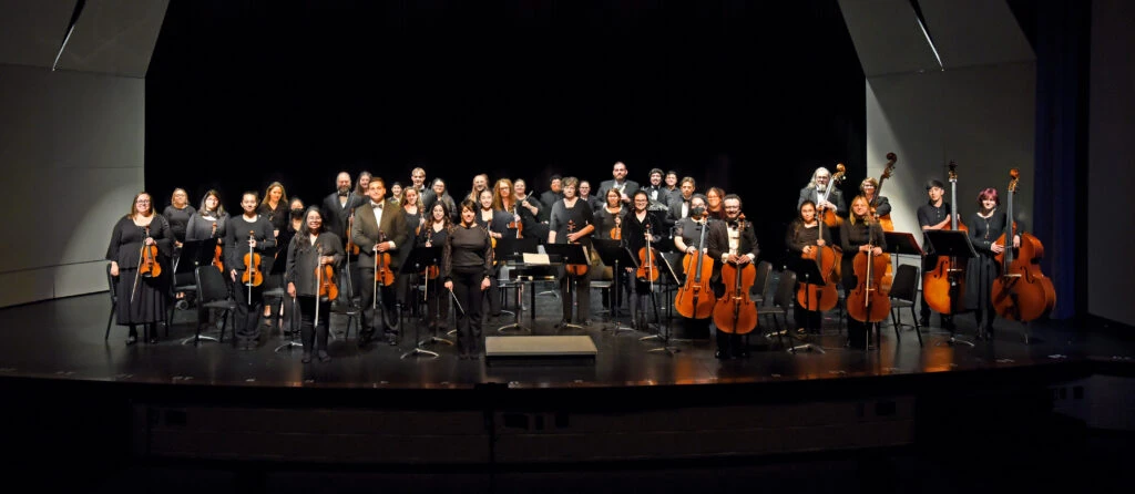 Orchestra group photo on stage.