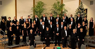 A formal group photo of a choir dressed in black attire