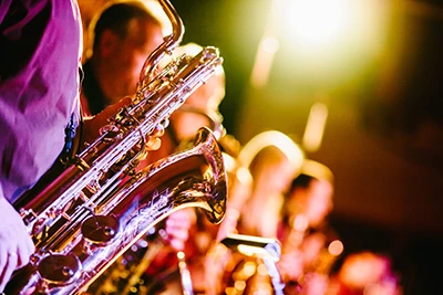 Close-up of saxophone players performing.